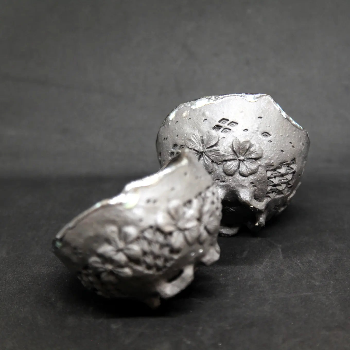 Blue cups on black clay - flower patterns