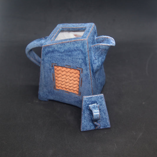 Navy blue teapot on red clay - braiding pattern