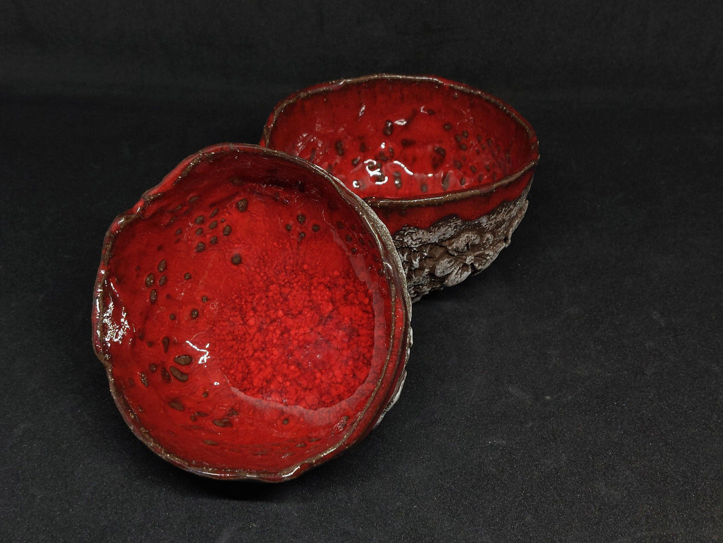 Red cups on black clay - flower patterns