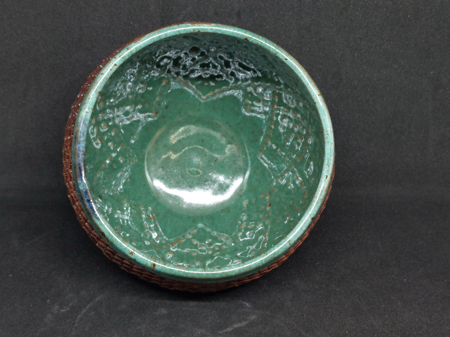 Green bowl on red clay - tartan pattern