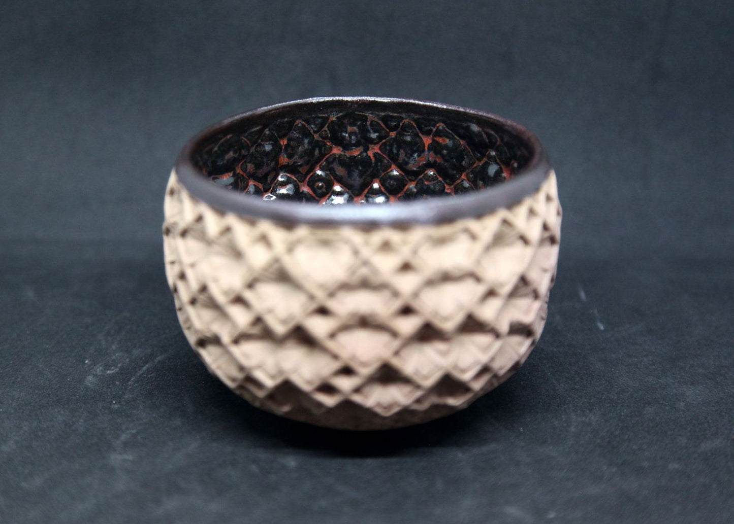 Black and red bowl on buff clay - hydrangea pattern