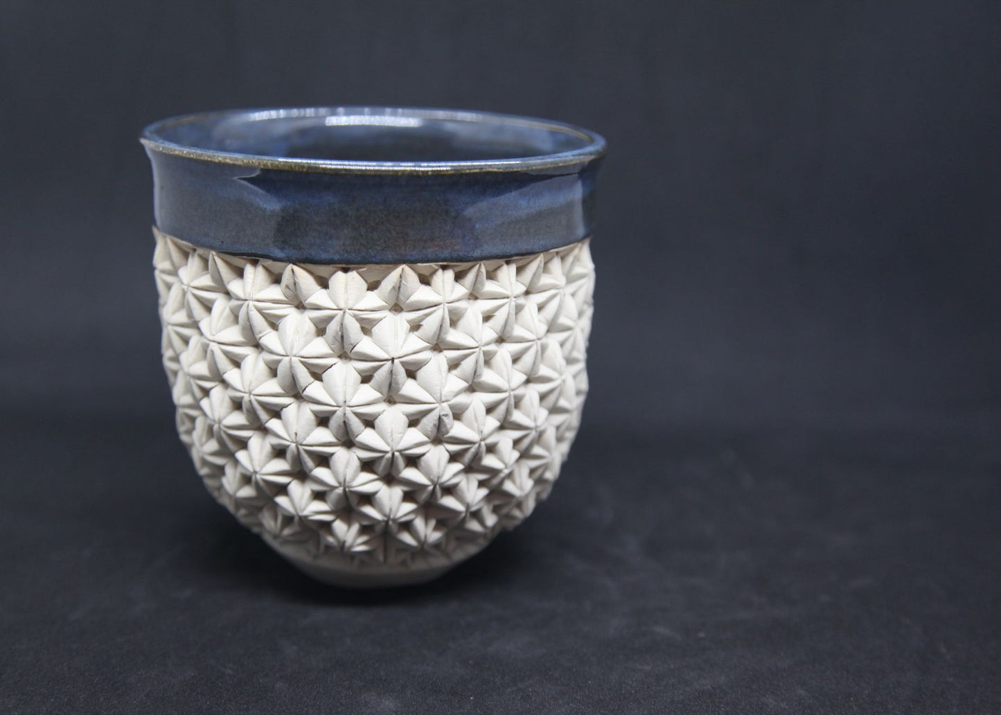 Blue bowl on white clay - origami pattern