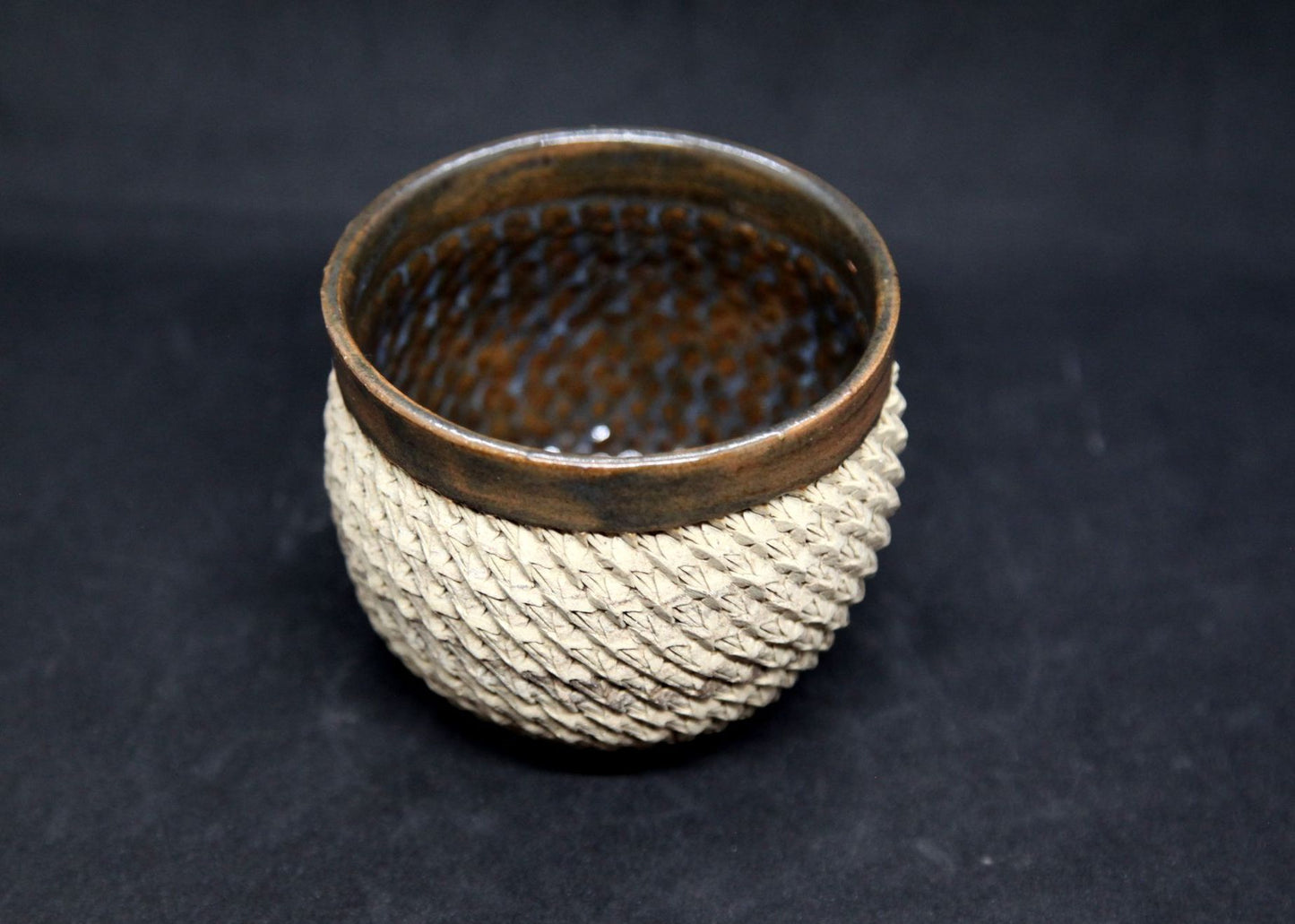 Brown and blue bowl on beige clay - braiding pattern