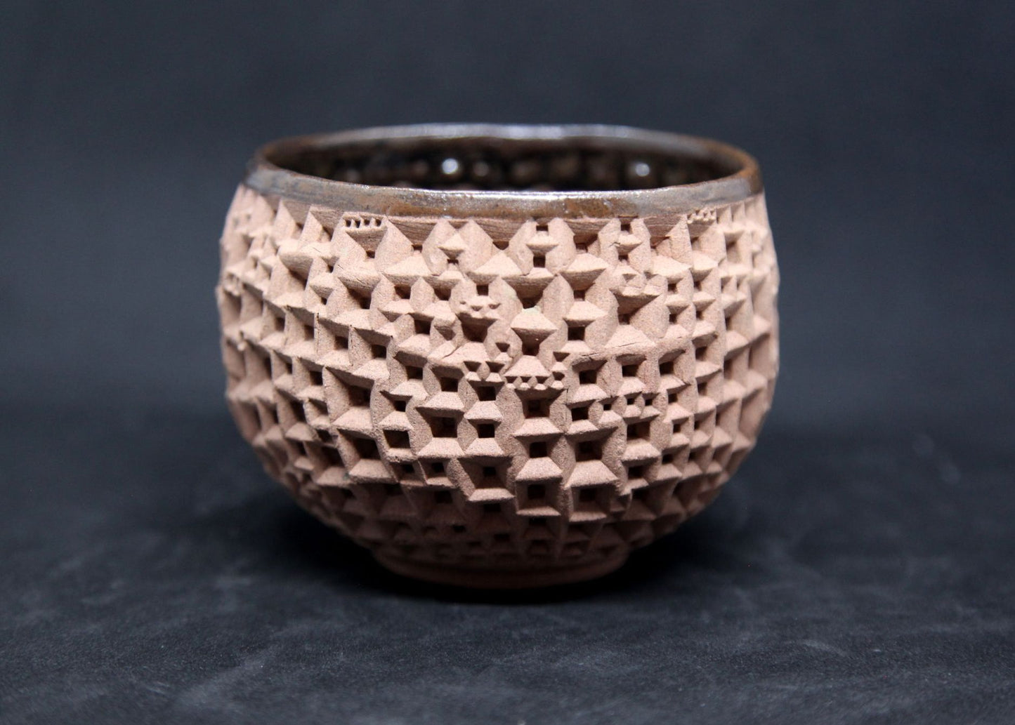 Iron tenmoku bowl on buff clay