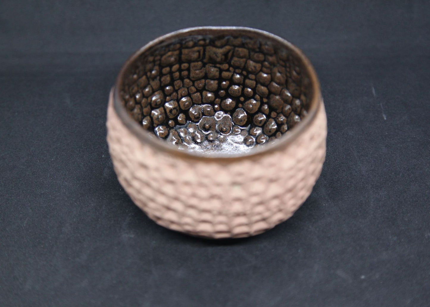 Iron tenmoku bowl on buff clay