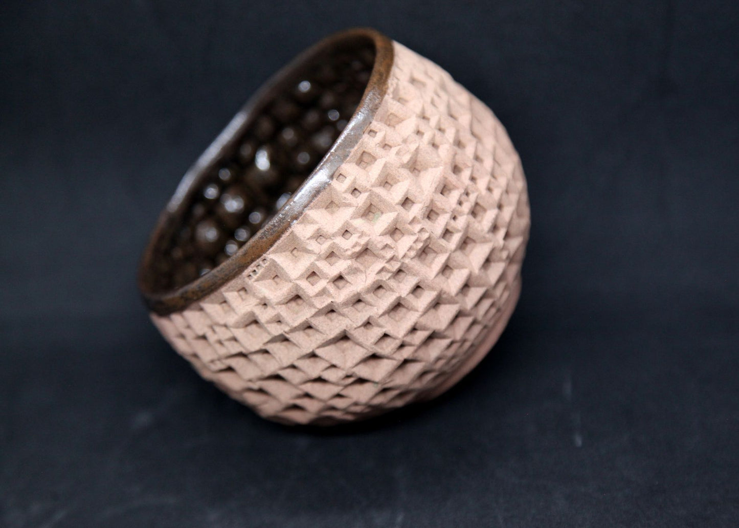 Iron tenmoku bowl on buff clay