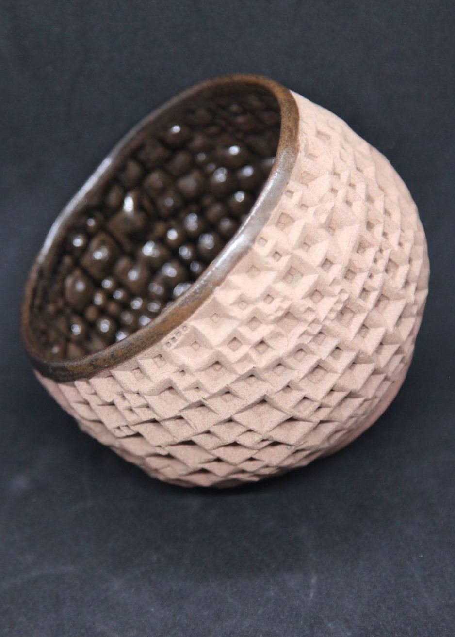 Iron tenmoku bowl on buff clay