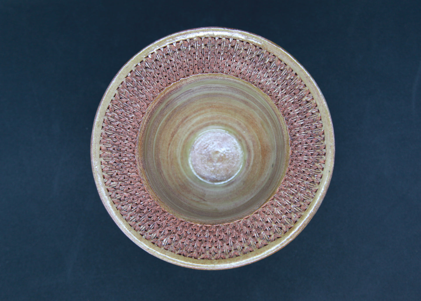 Green marli bowl on red glaze - braiding pattern