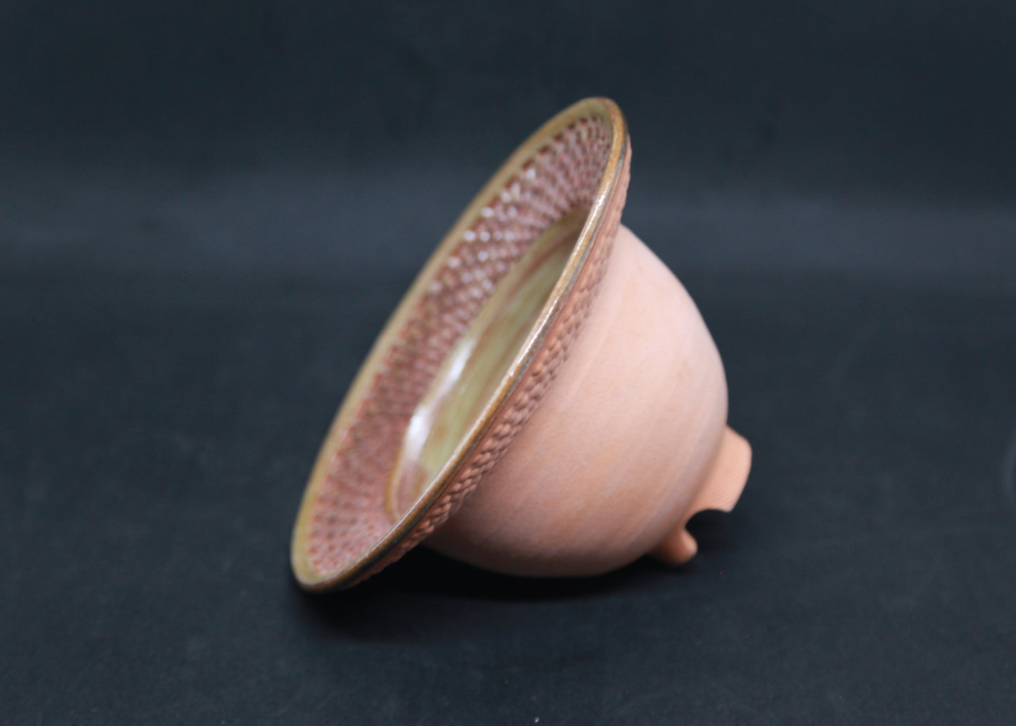 Green marli bowl on red glaze - braiding pattern