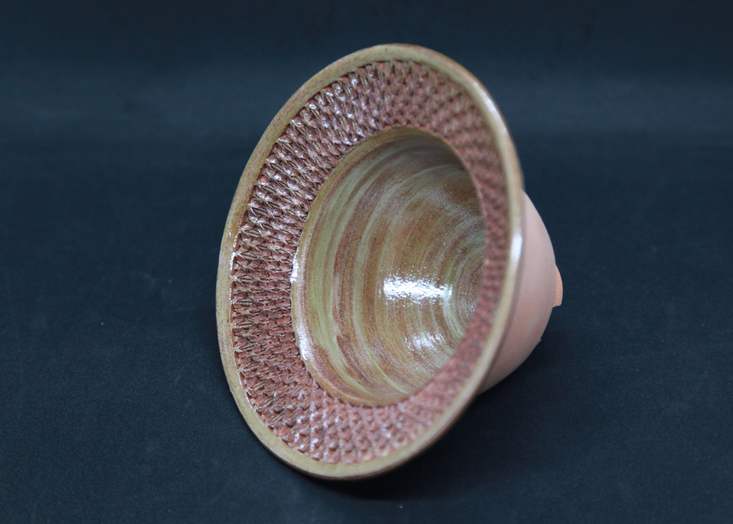 Green marli bowl on red glaze - braiding pattern