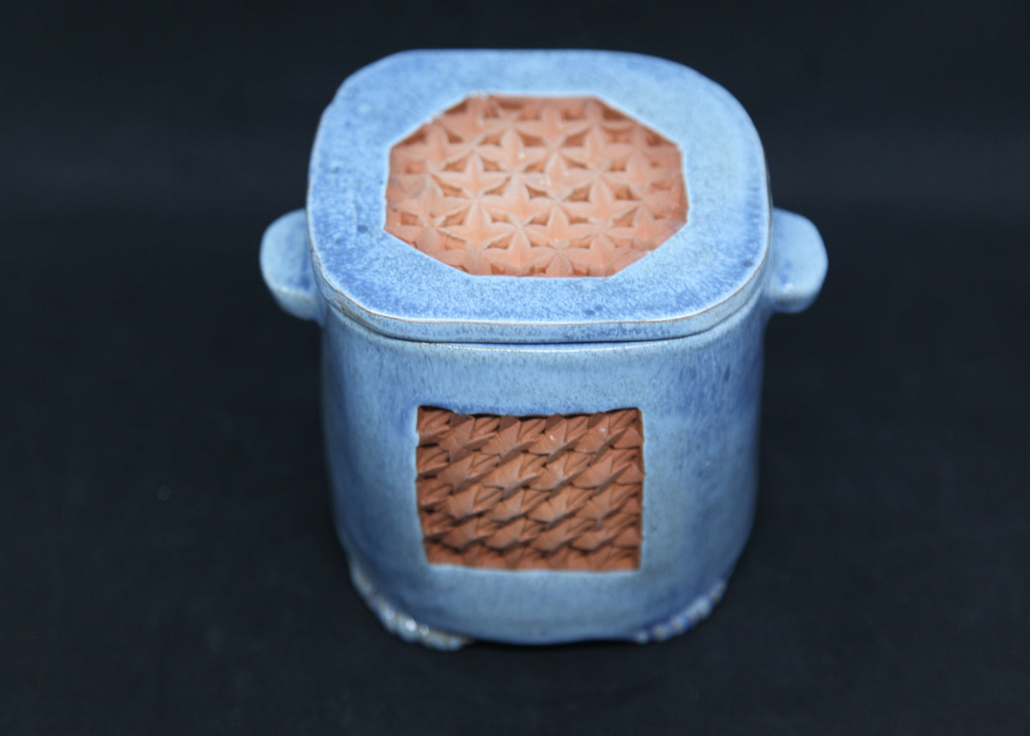 Blue tea box on red clay - origami pattern