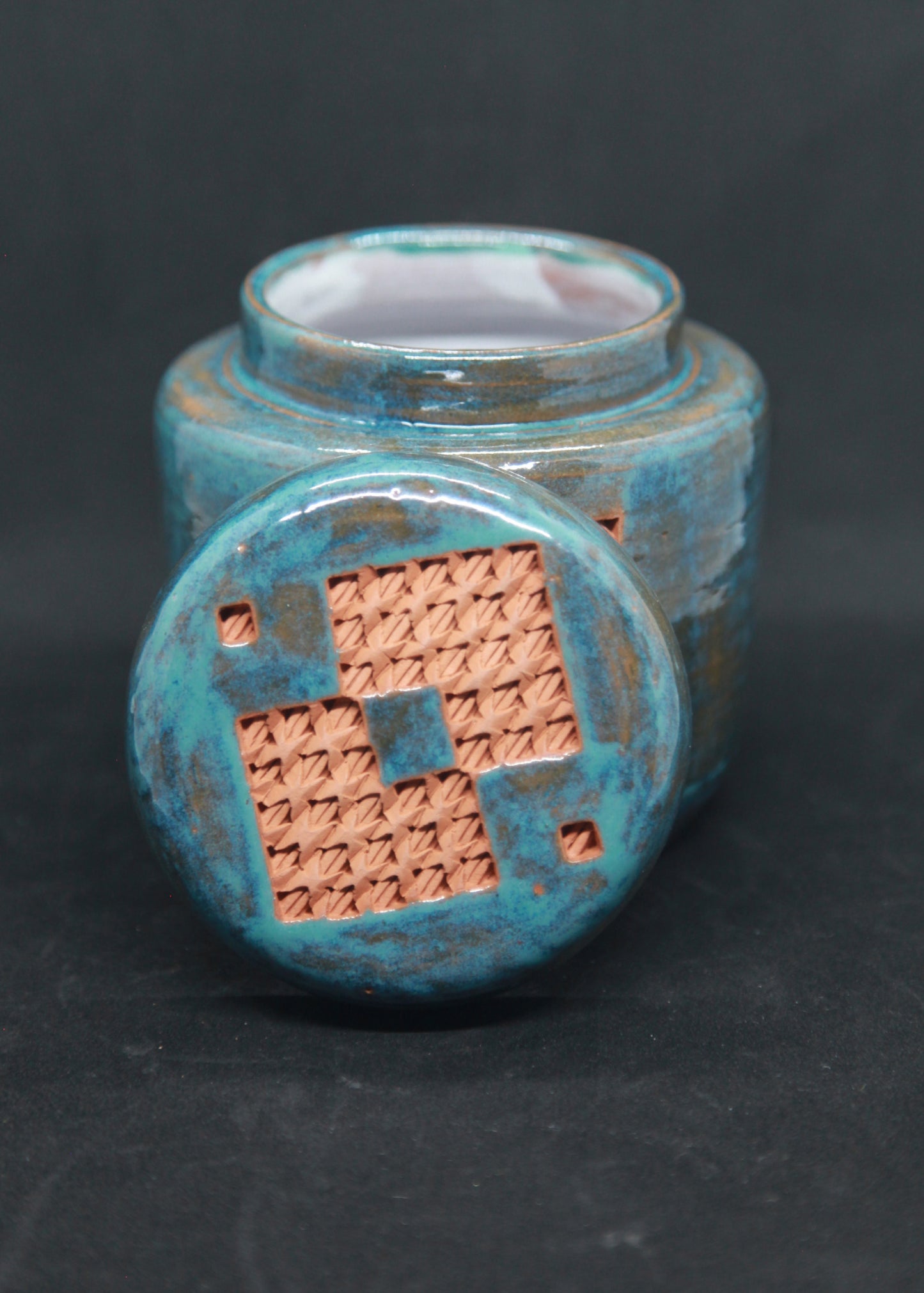 Turquoise blue tea box on red clay - braiding pattern