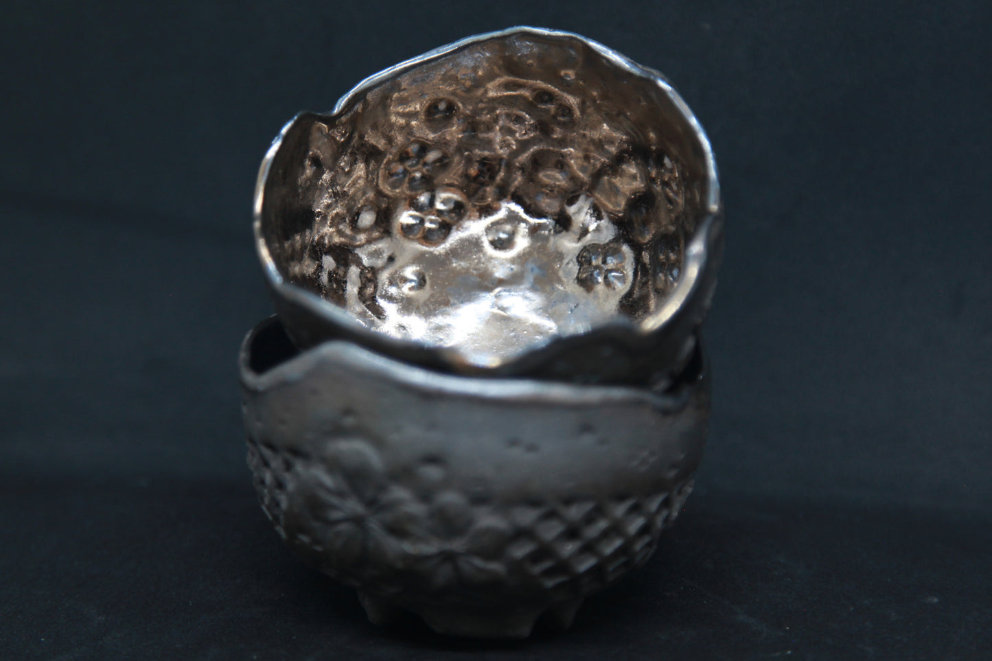 Golden color cups on red clay - flower patterns