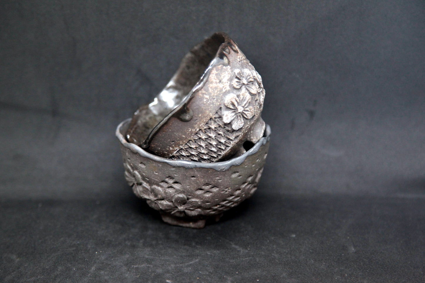 Black cups on black clay - flower patterns