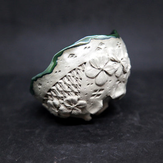 Metal green cup on light green clay - flower patterns