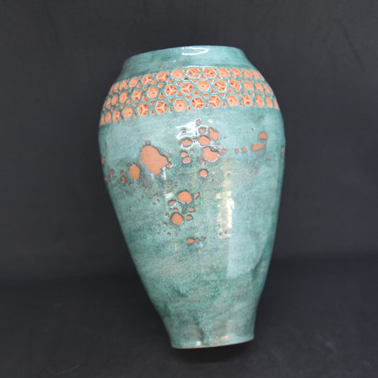 Green vase on red clay - origami pattern