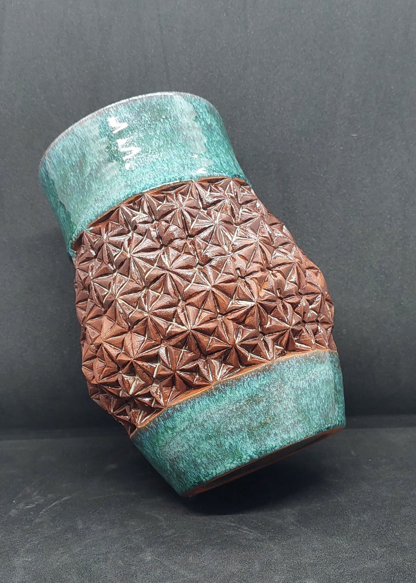 Vase vert sur terre rouge - motif origami