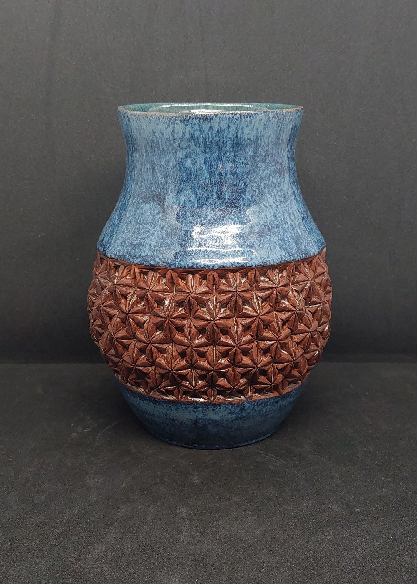 Blue vase on red clay - origami pattern
