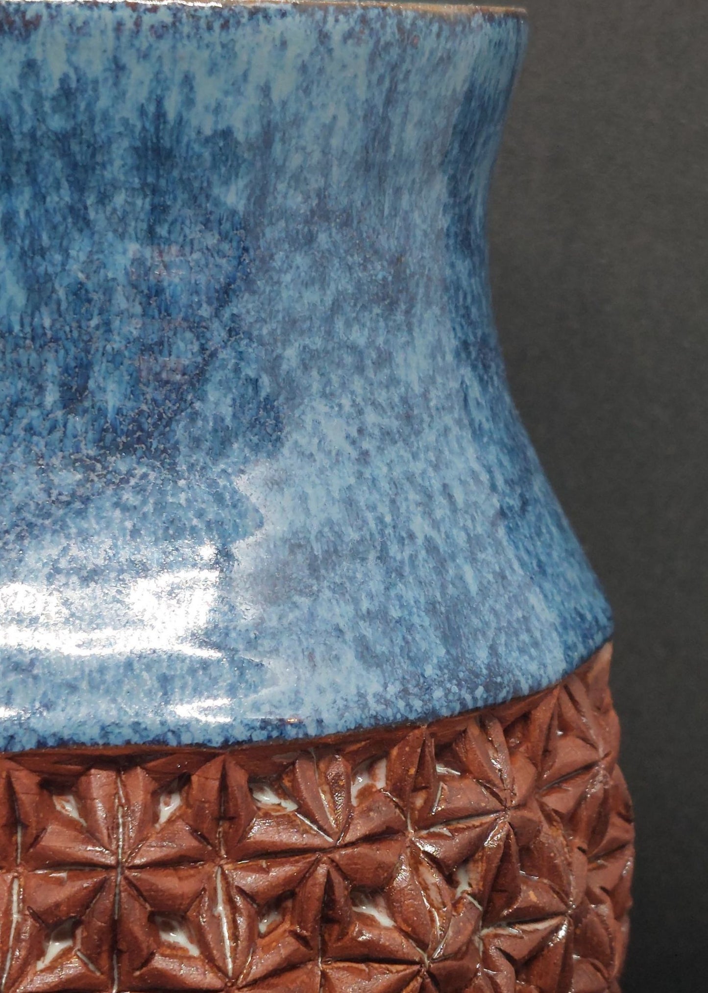 Blue vase on red clay - origami pattern