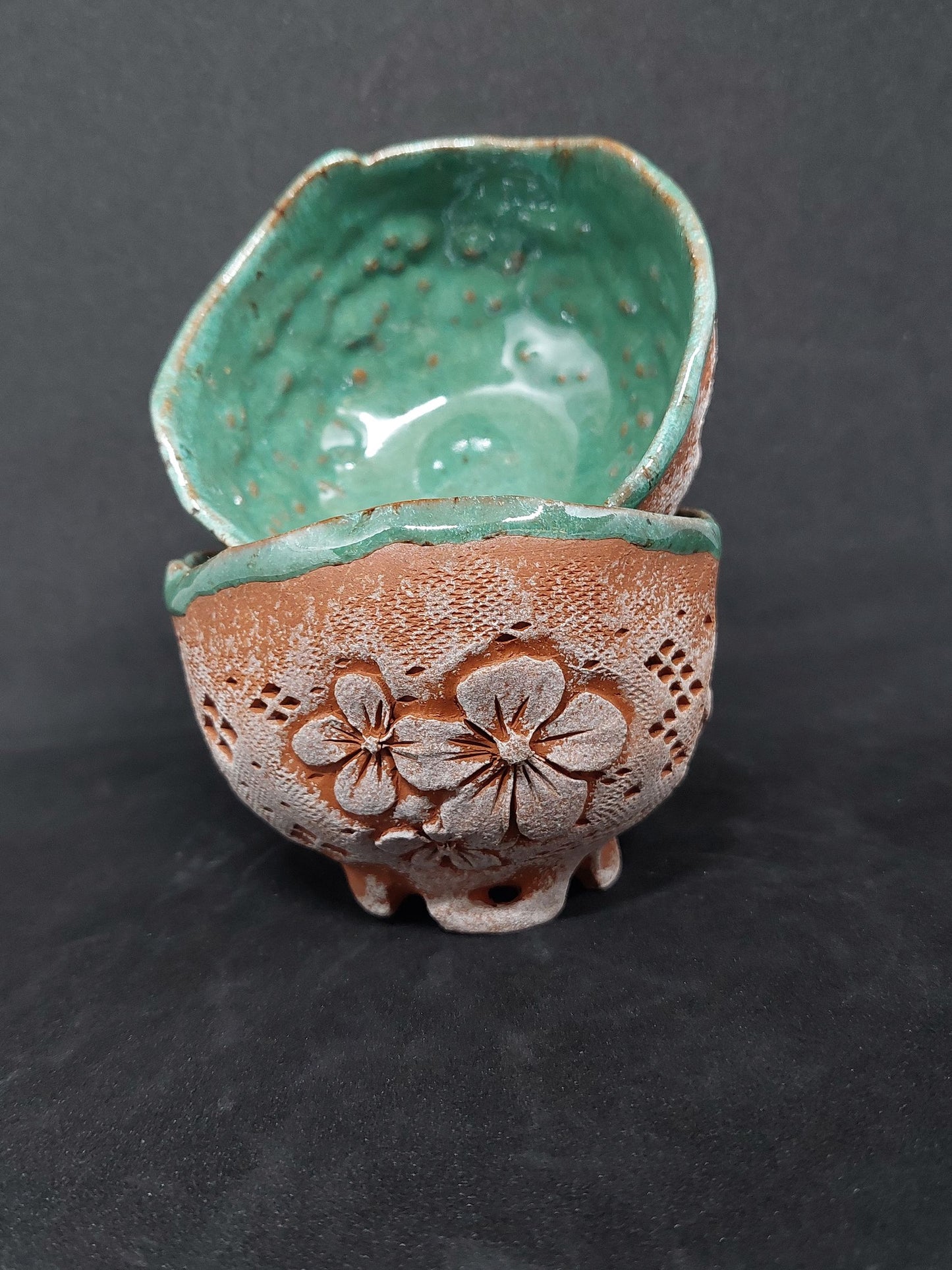 Green cups on red clay - flower patterns