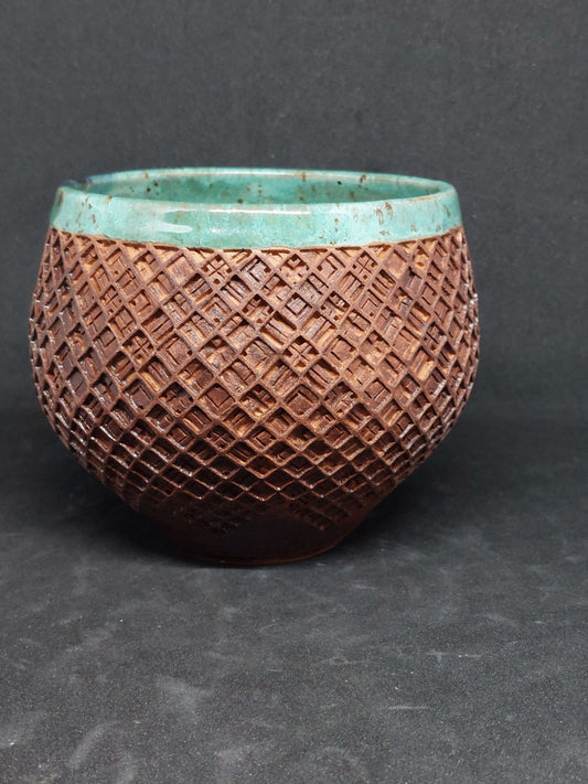 Green bowl on red clay - tartan pattern