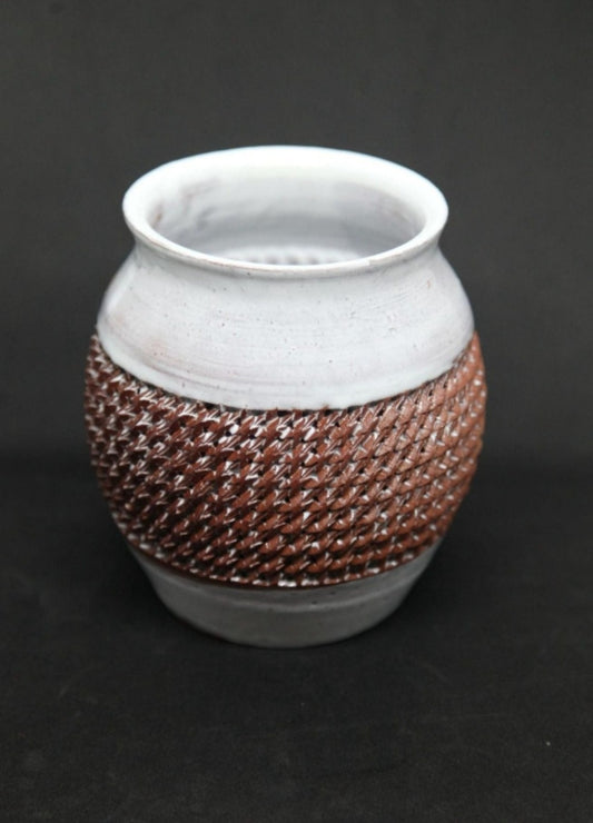 White vase on red clay - braiding pattern