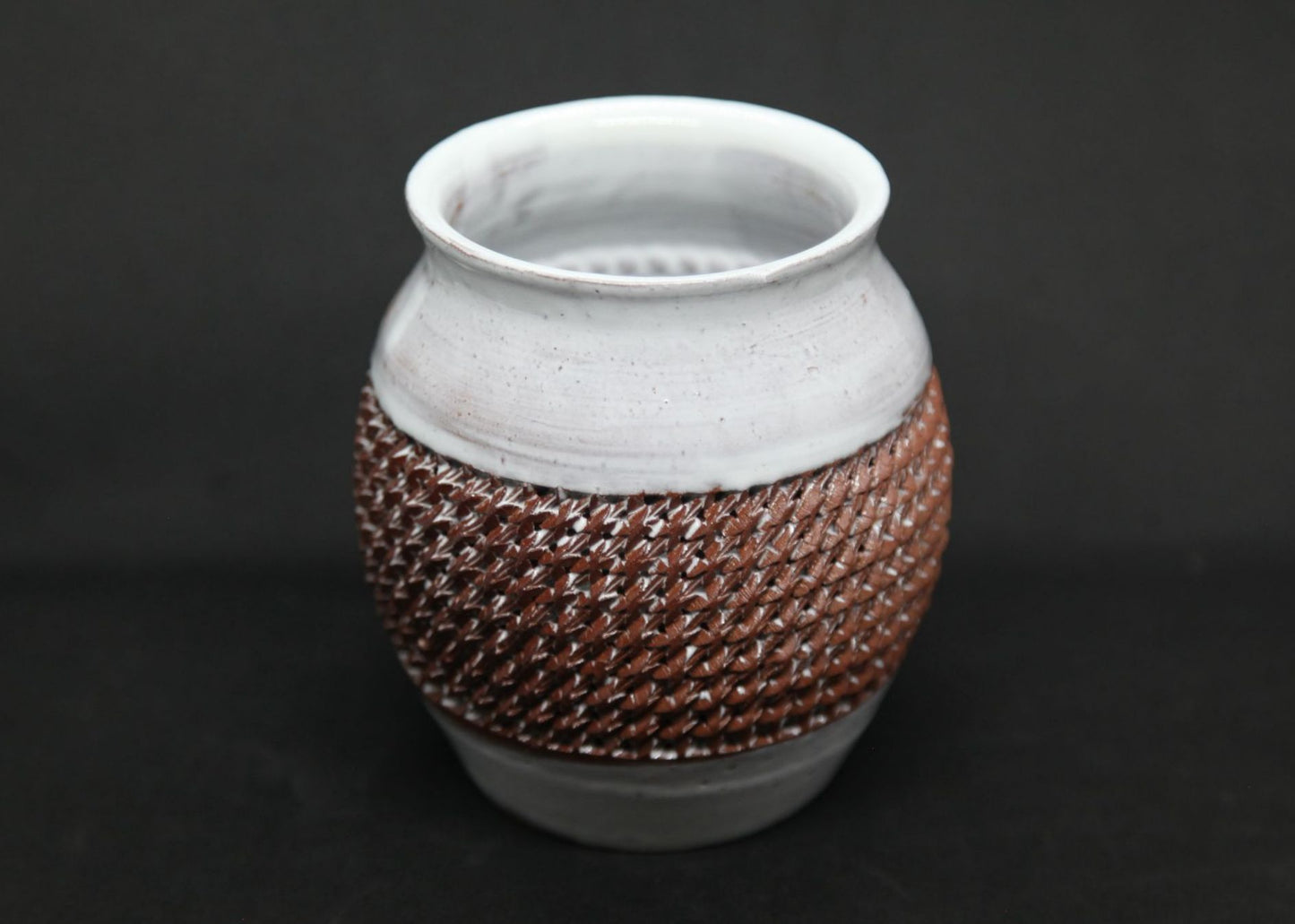 White vase on red clay - braiding pattern