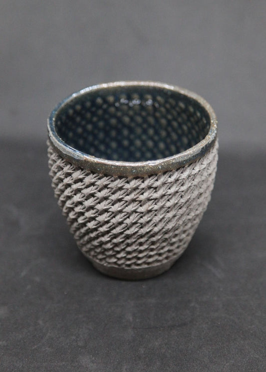 Blue mug on gray clay - braiding pattern