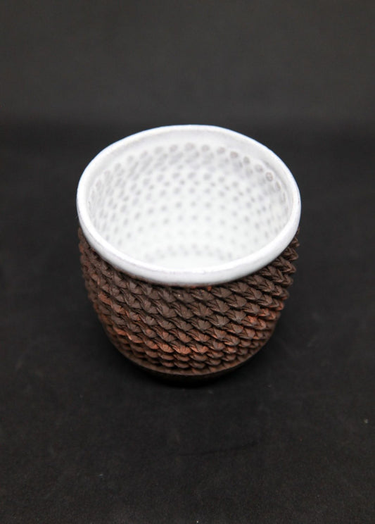 White mug on black clay - braiding pattern