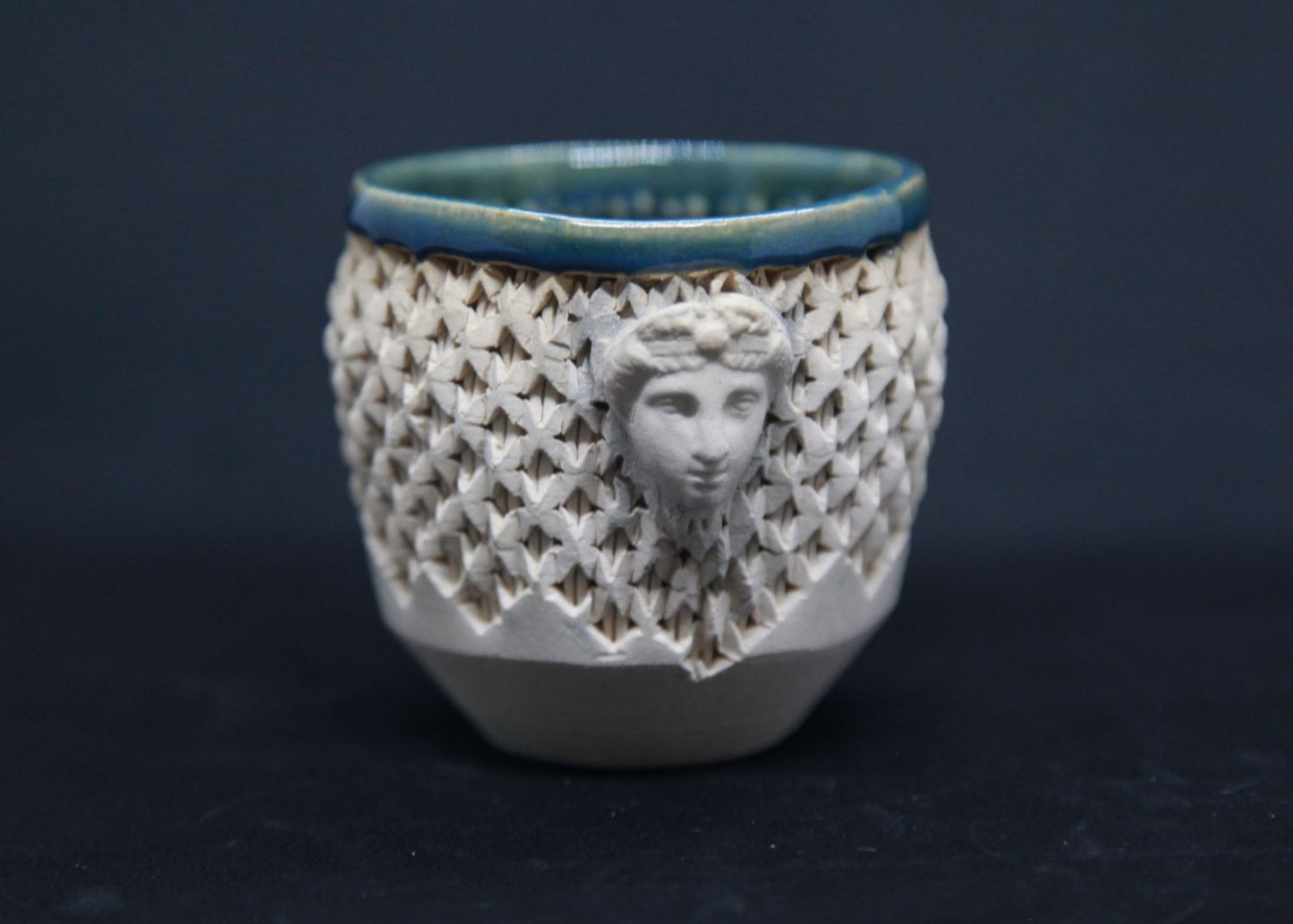 Green cup on white clay, Diane face - braiding pattern