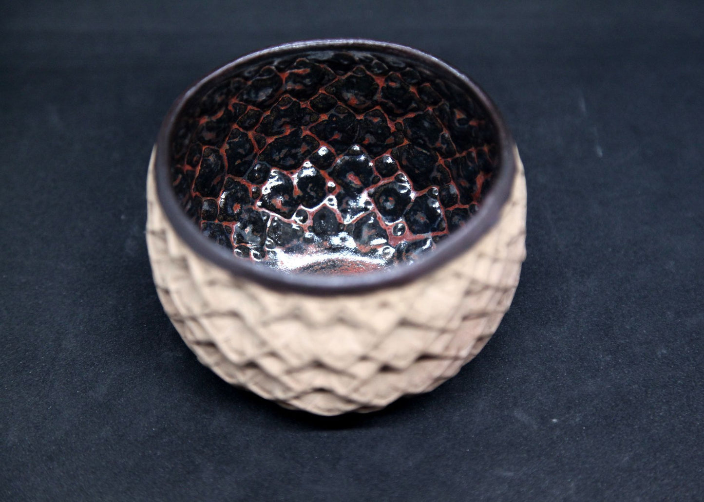 Black and red bowl on buff clay - hydrangea pattern