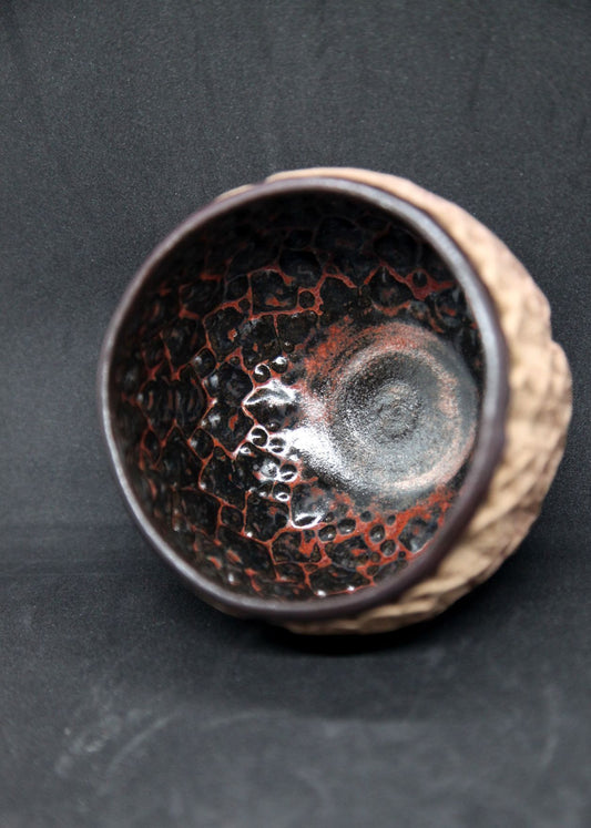 Black and red bowl on buff clay - hydrangea pattern