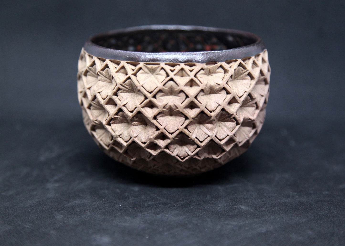 Black and red bowl on buff clay - hydrangea pattern