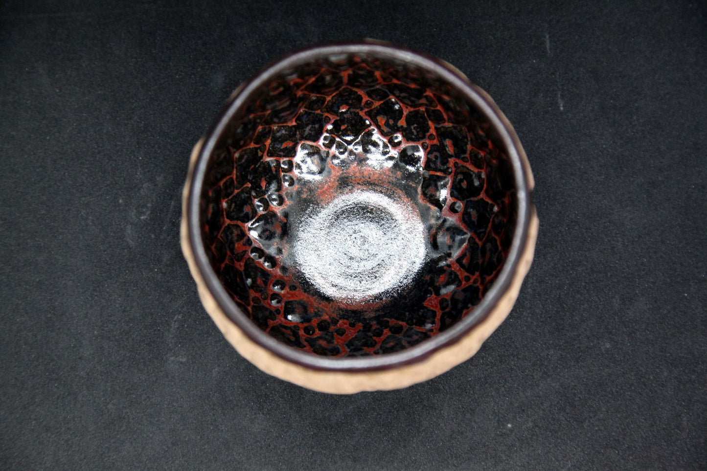 Black and red bowl on buff clay - hydrangea pattern