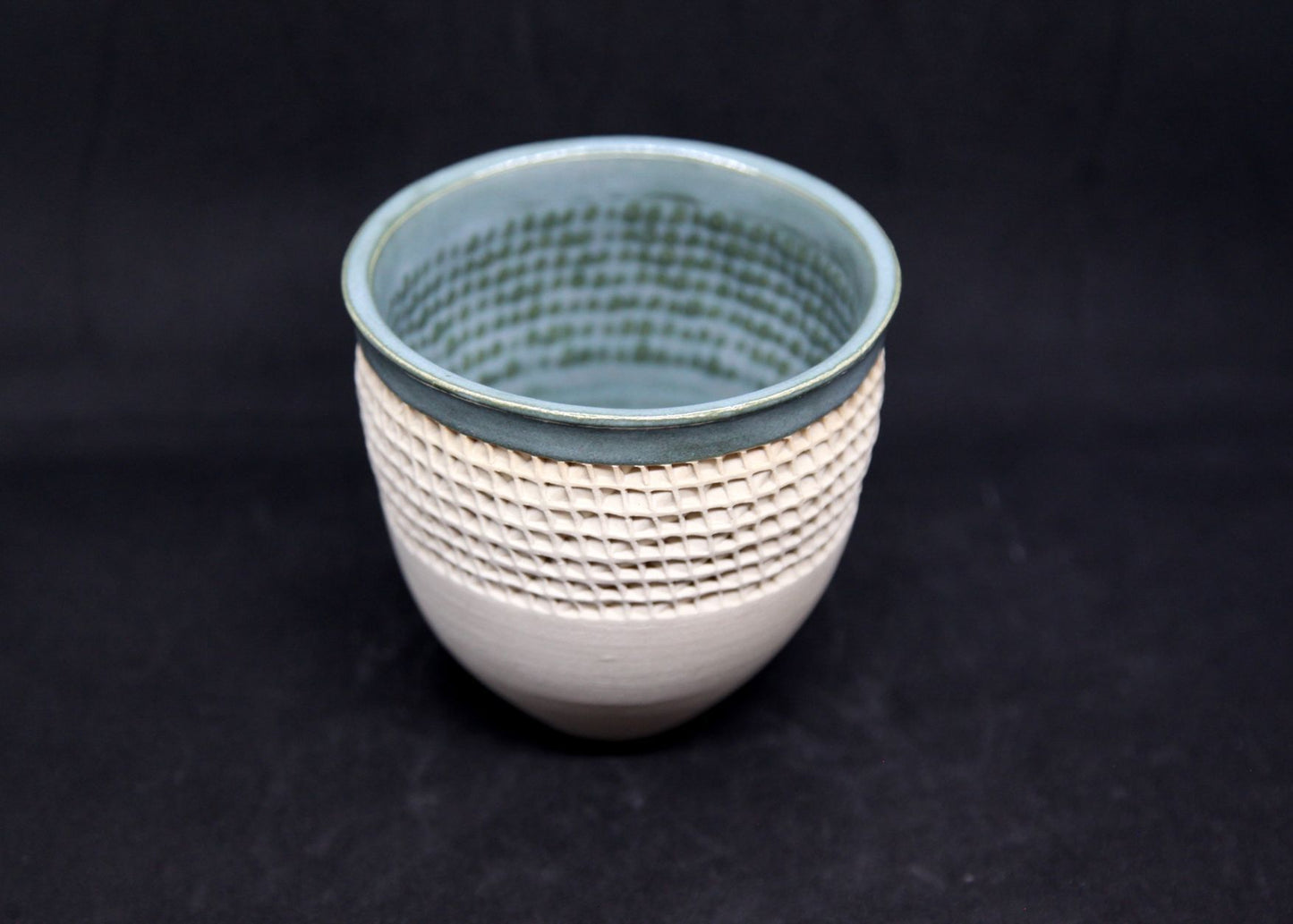 Green bowl on white clay, twisted pattern