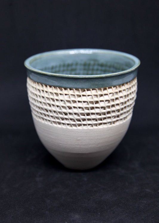 Green bowl on white clay, twisted pattern