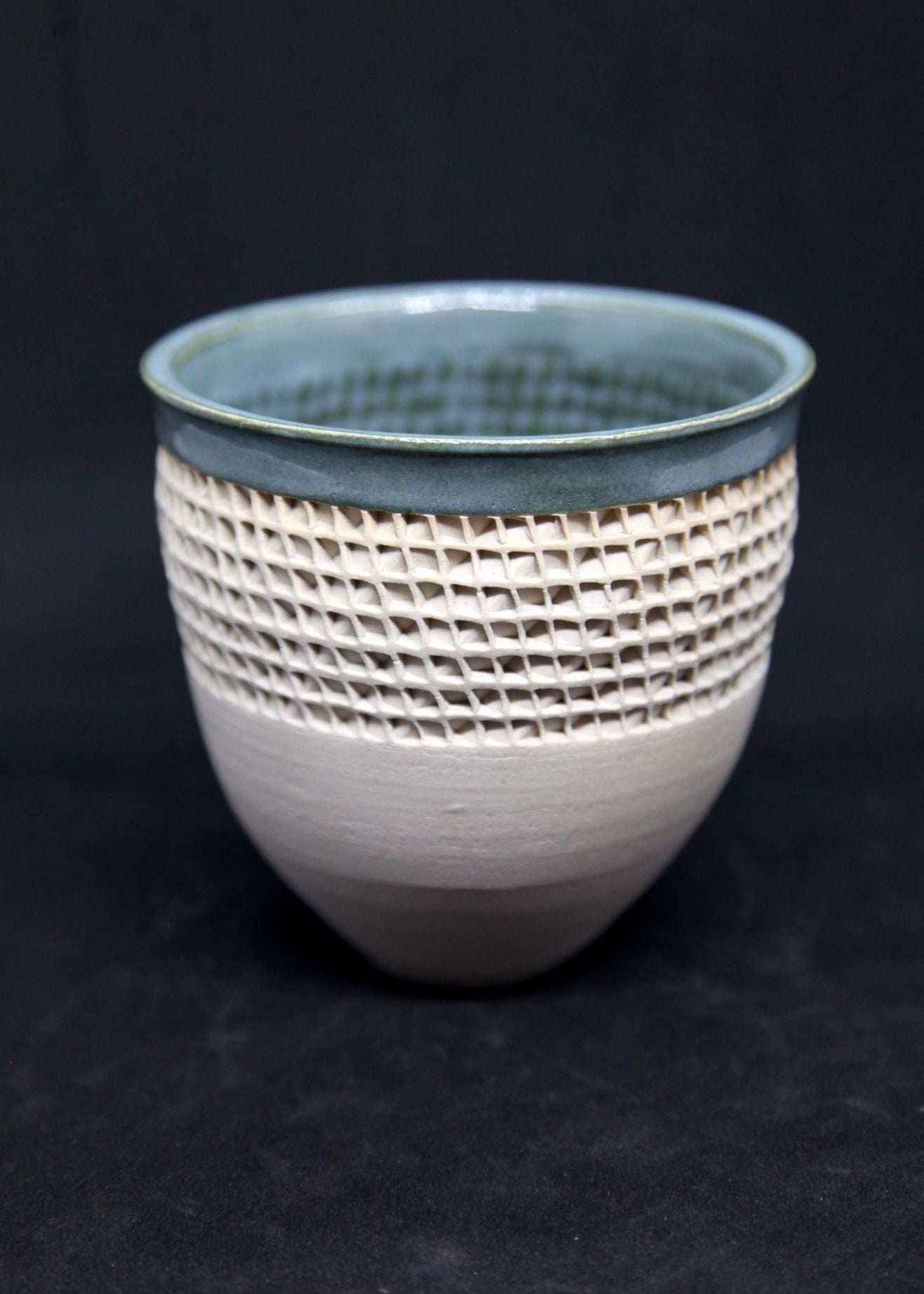 Green bowl on white clay, twisted pattern