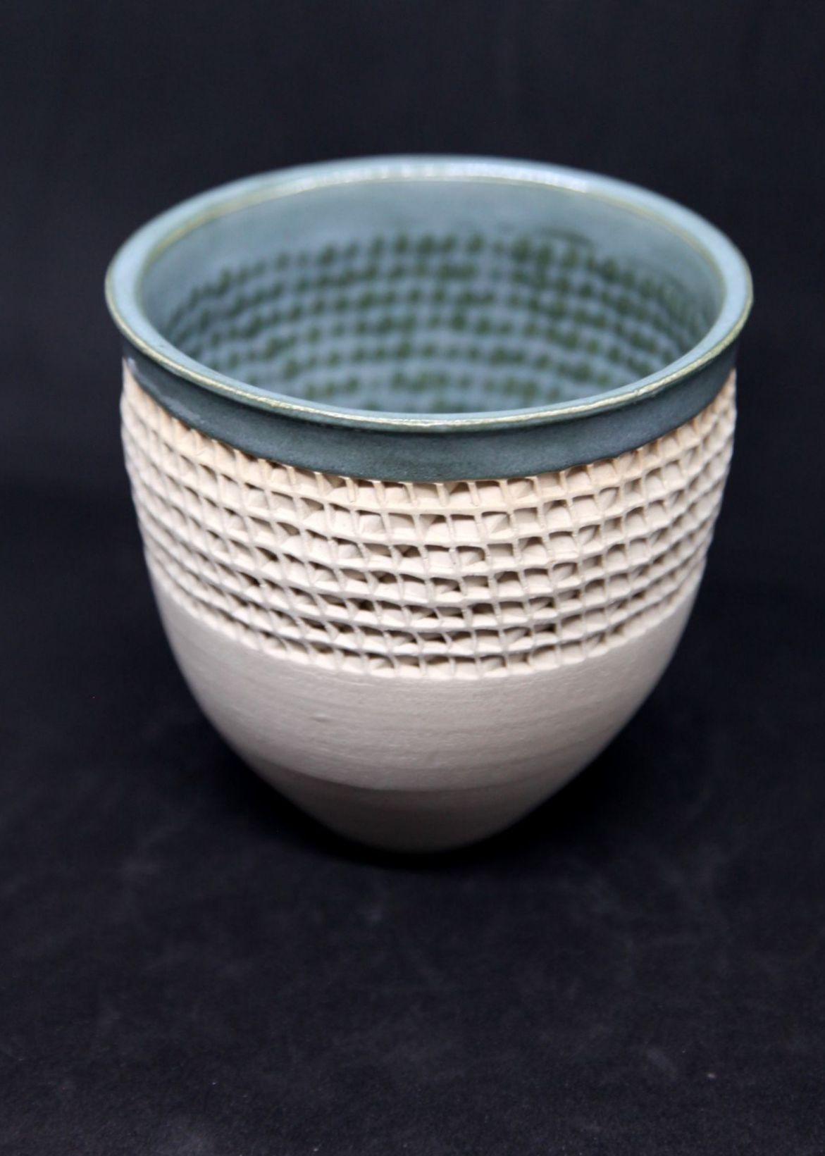 Green bowl on white clay, twisted pattern