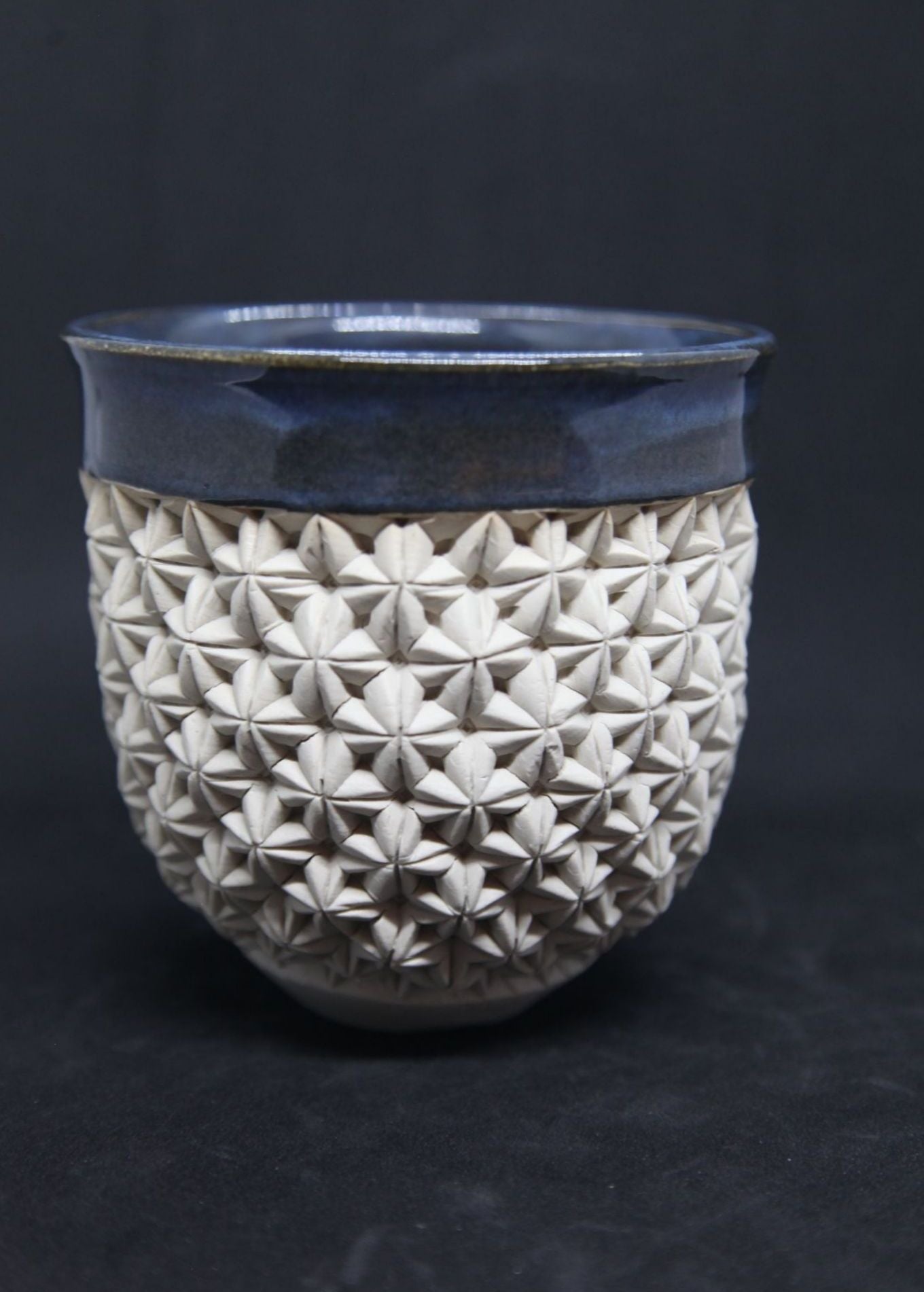 Blue bowl on white clay - origami pattern