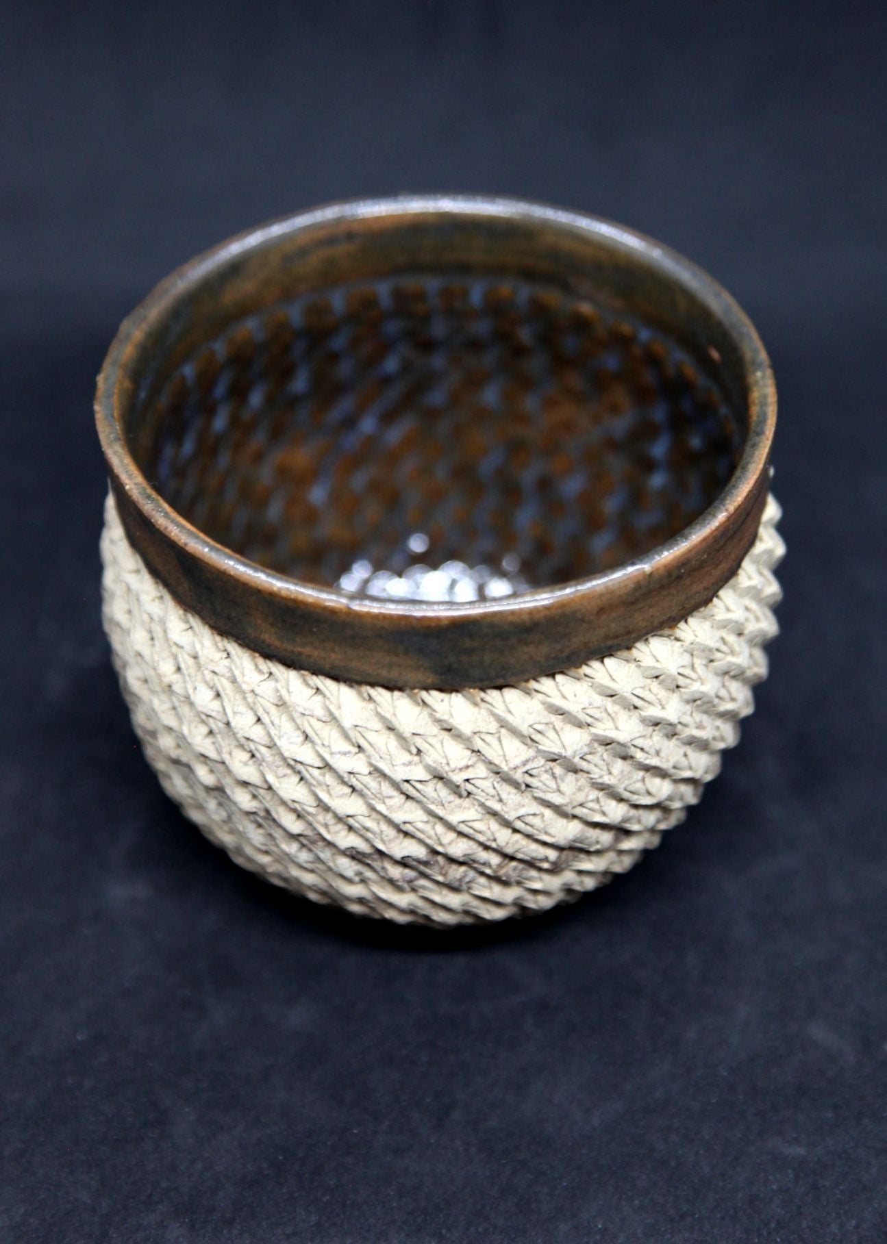 Brown and blue bowl on beige clay - braiding pattern