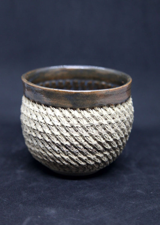 Brown and blue bowl on beige clay - braiding pattern