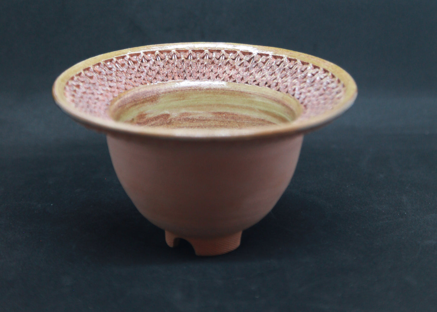 Green marli bowl on red glaze - braiding pattern