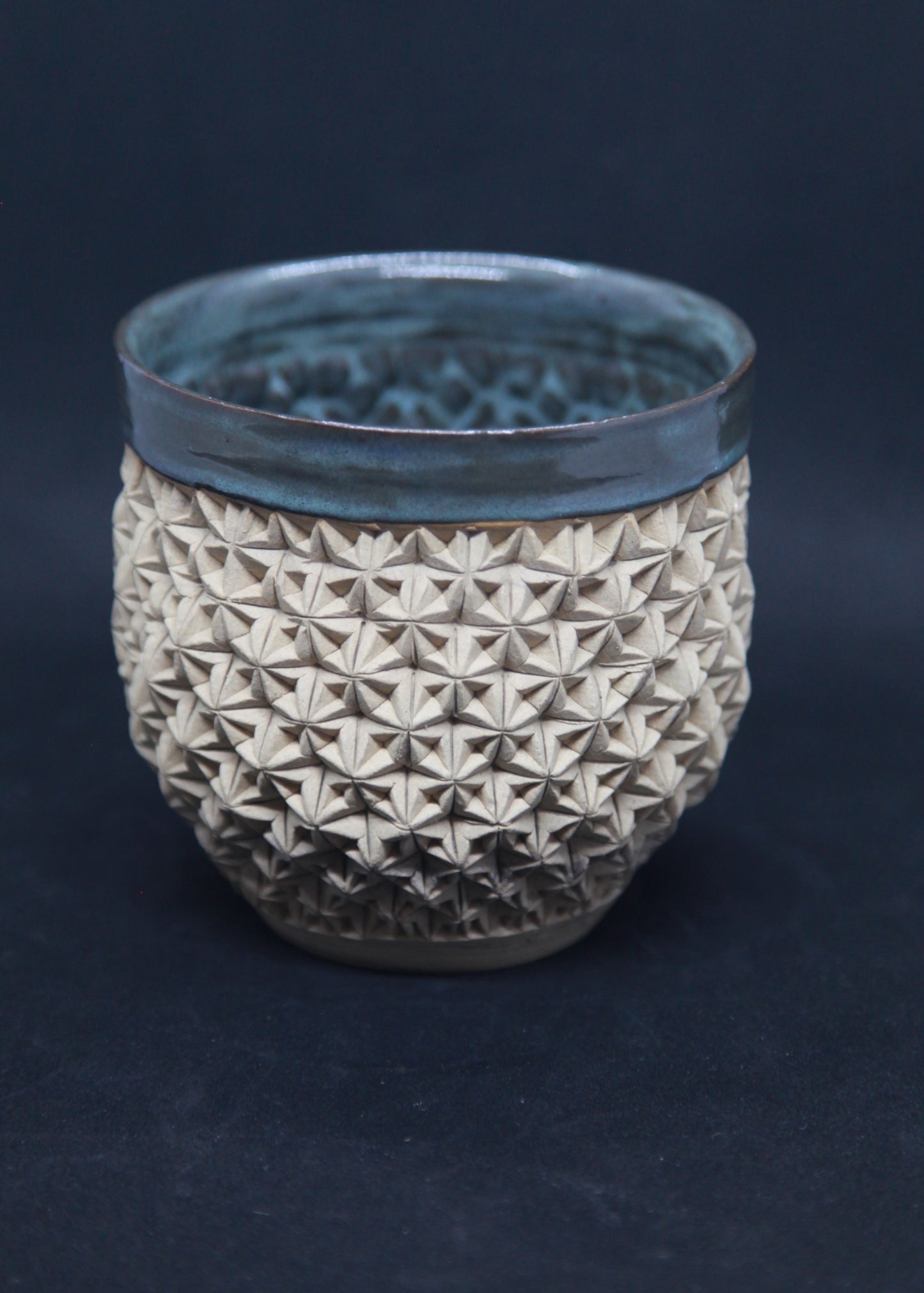 Green and blue bowl on ivory clay - origami pattern