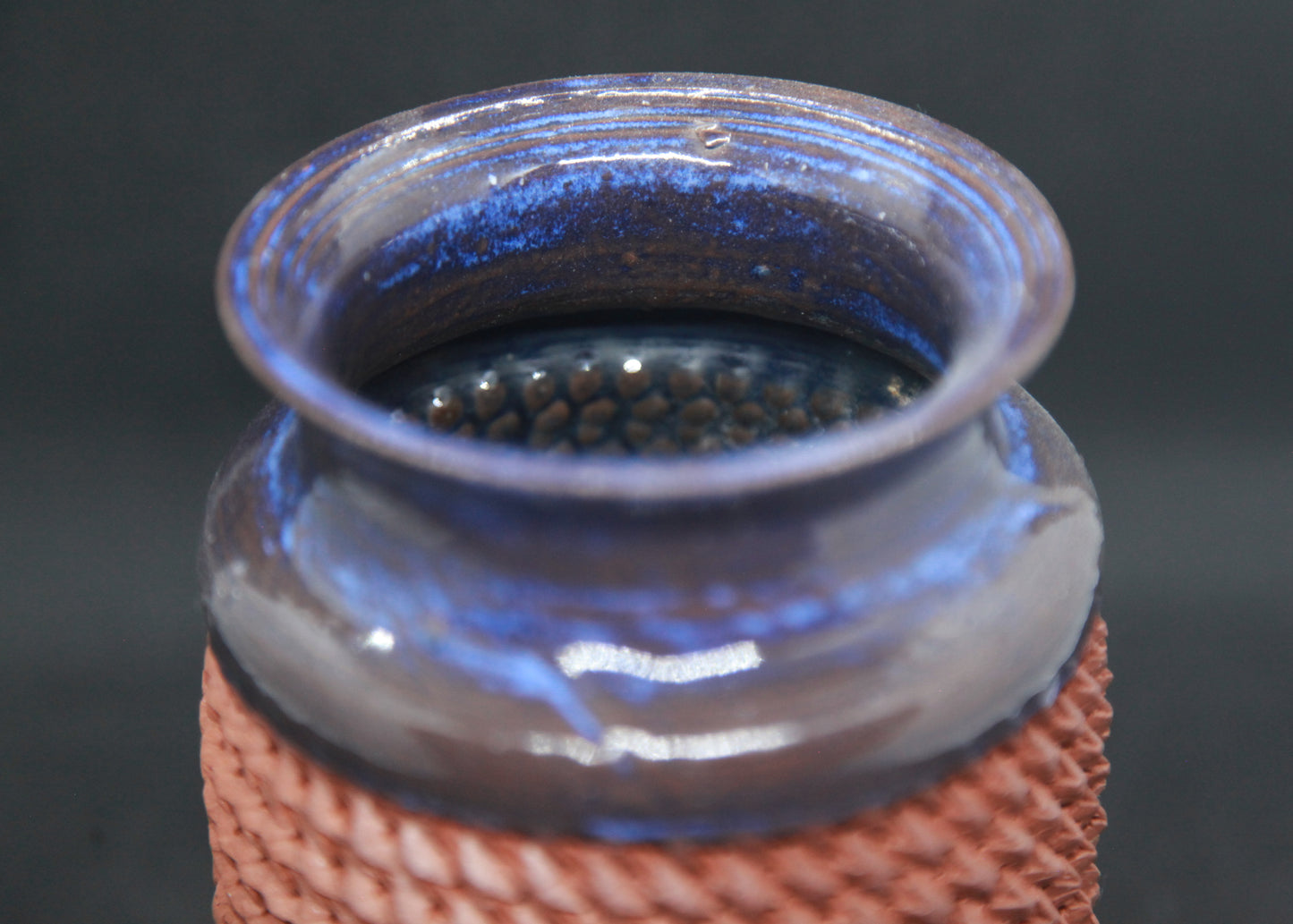 Blue vase on red glaze - braiding pattern