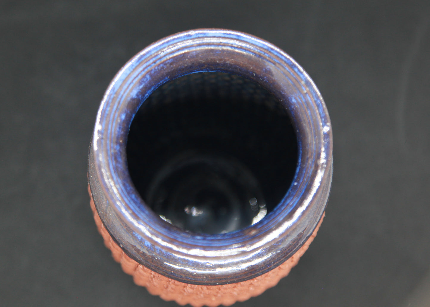 Blue vase on red glaze - braiding pattern