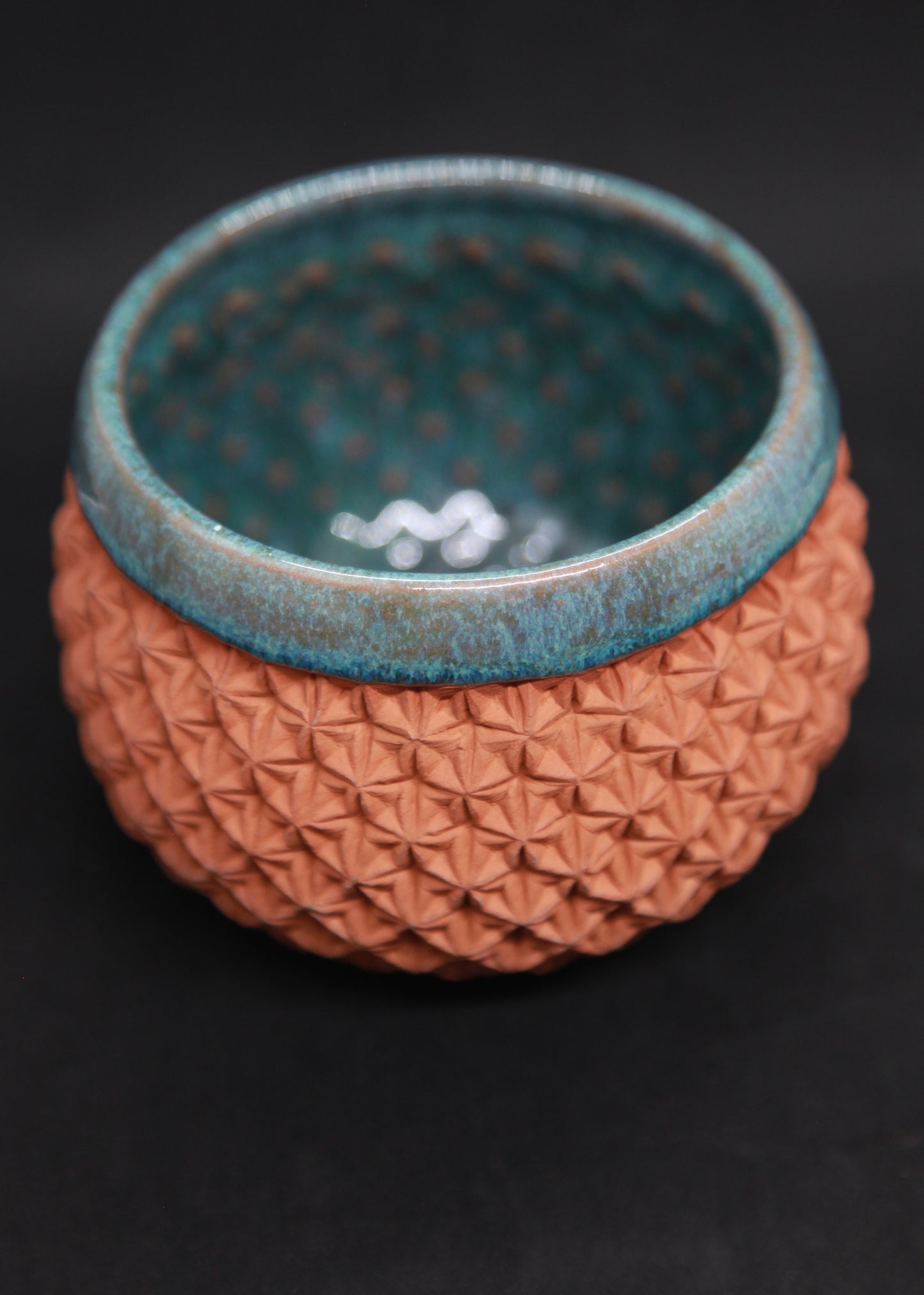 Green bowl on red glaze - origami pattern