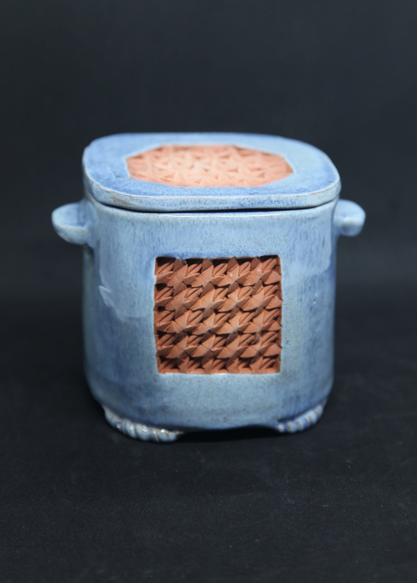 Blue tea box on red clay - origami pattern