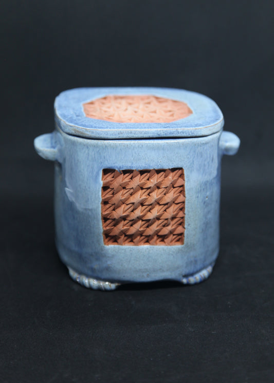 Blue tea box on red clay - origami pattern