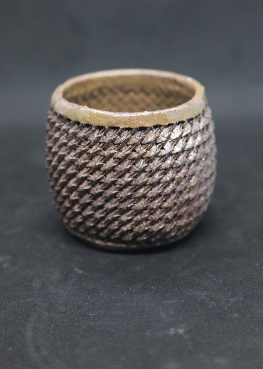 Bronze cup on black clay - braiding pattern