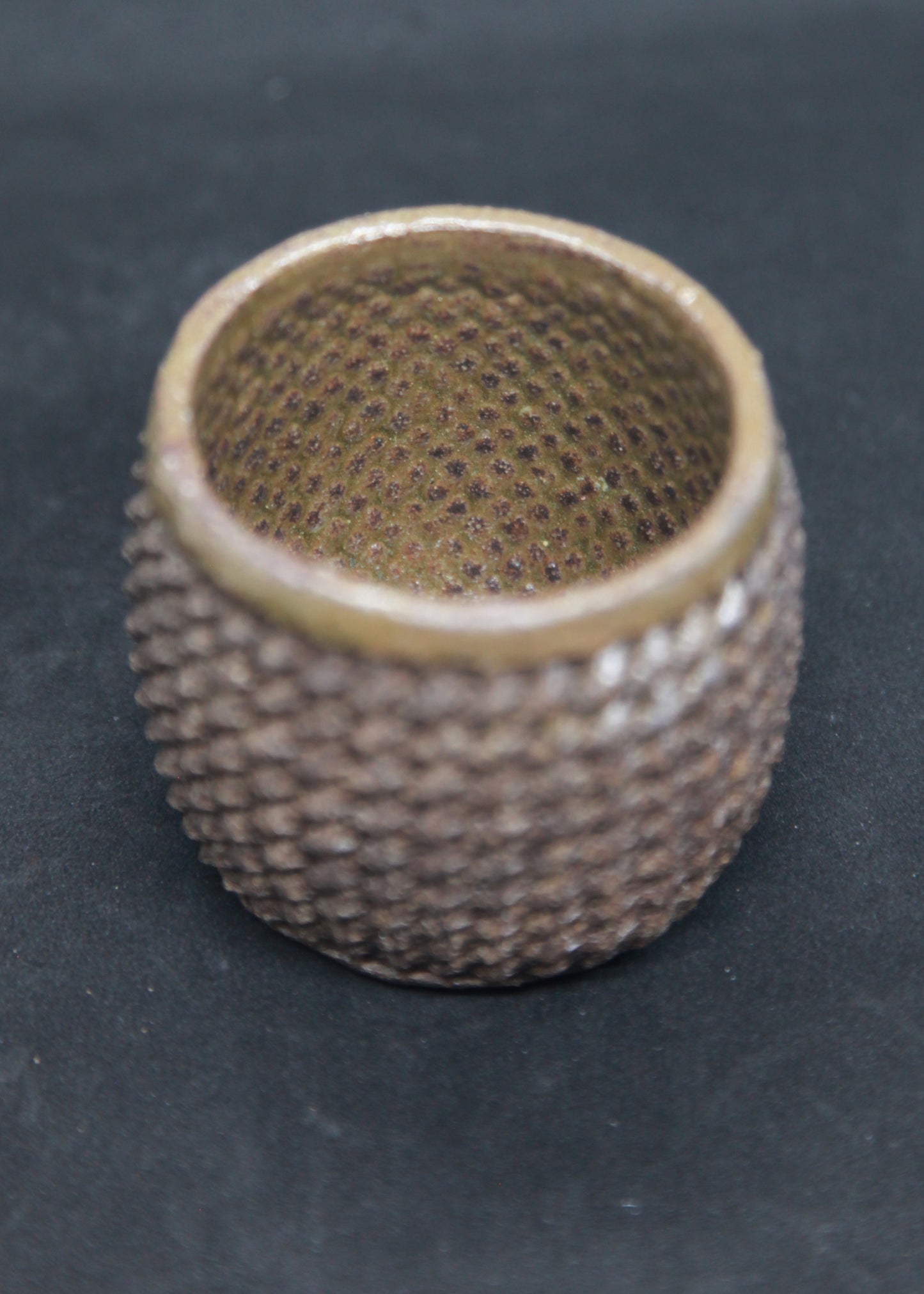 Bronze cup on black clay - braiding pattern